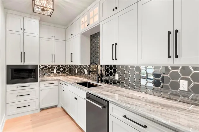 a view of a kitchen with white cabinets
