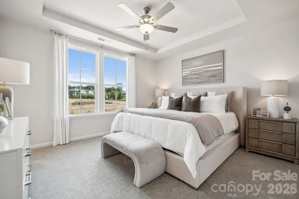 a spacious bedroom with a bed and a window