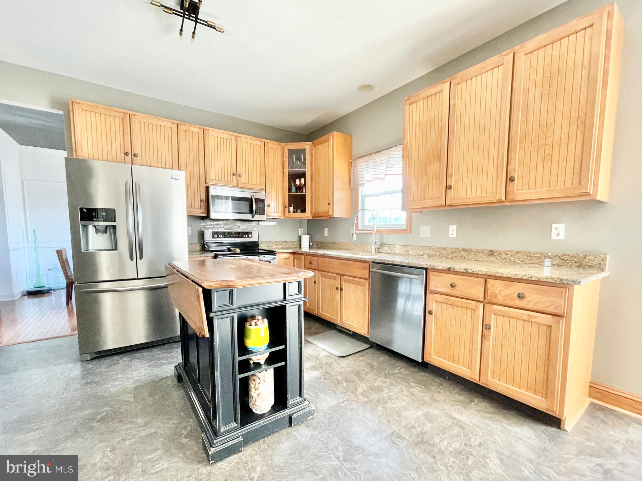 78 Jillian Drive Dover, DE 19901 - Photo 11 of 42 a kitchen with stainless steel appliances granite countertop a stove a refrigerator and a sink