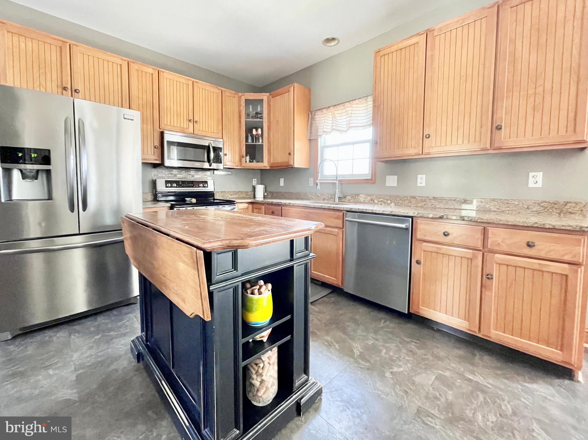 78 Jillian Drive Dover, DE 19901 - Photo 12 of 42 a kitchen with stainless steel appliances granite countertop a stove a sink a refrigerator and white cabinets