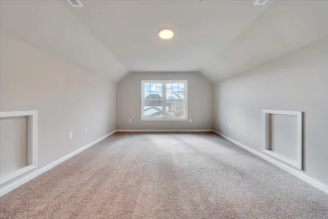 an empty room with a window and ceiling fan