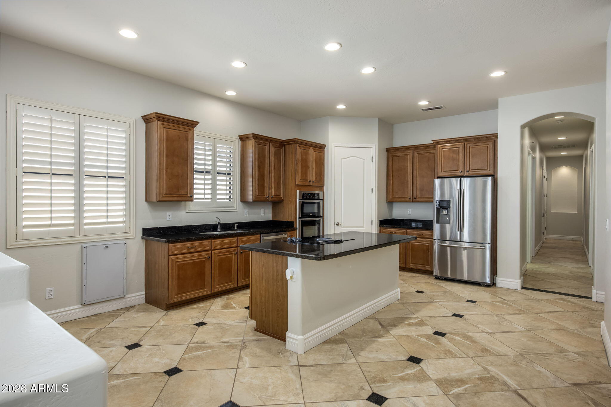 3215 East Constance Way Phoenix, AZ 85042 - Photo 11 of 40 a kitchen with stainless steel appliances granite countertop a sink stove and refrigerator