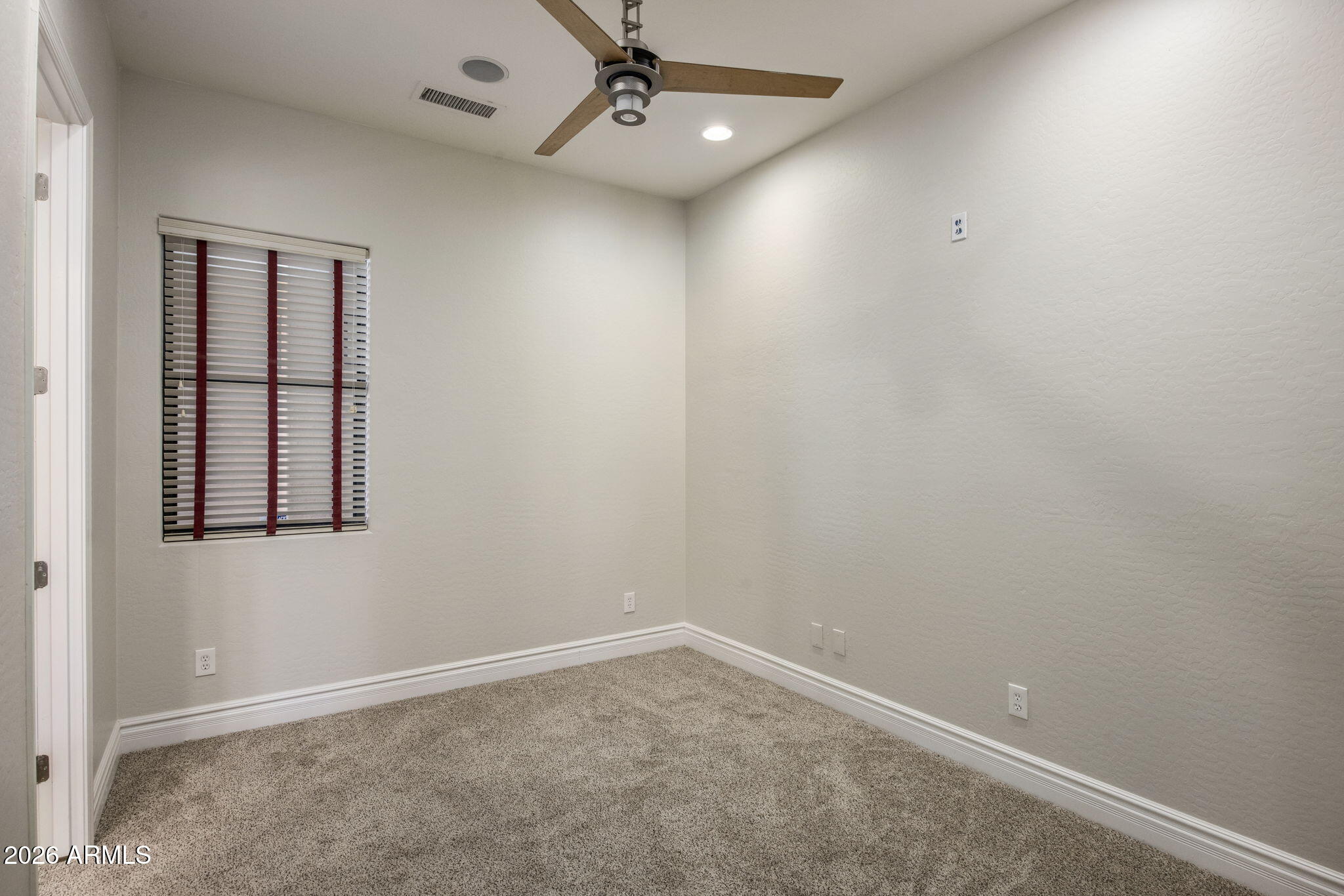 3215 East Constance Way Phoenix, AZ 85042 - Photo 15 of 40 en empty room with windows and ceiling fan