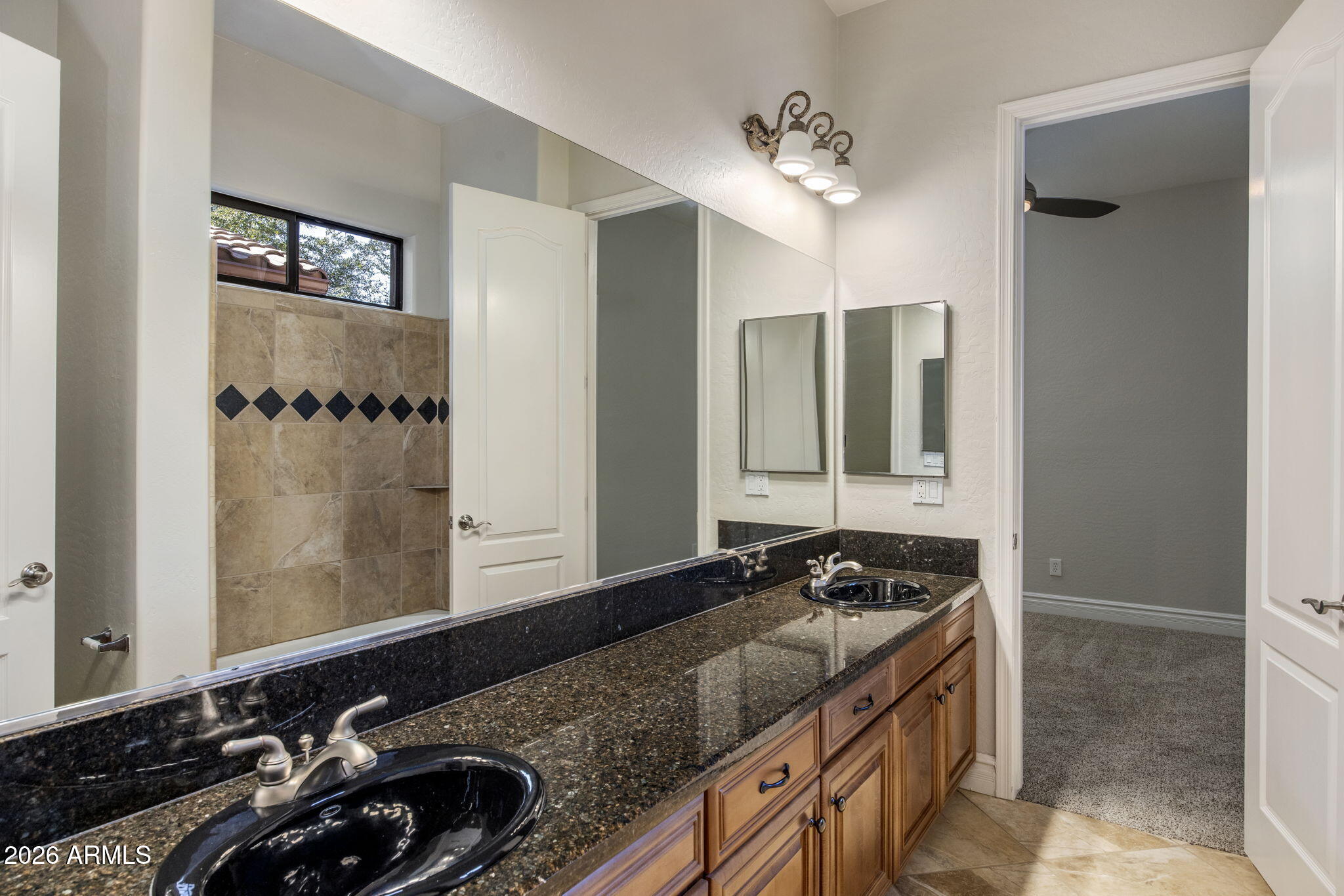 3215 East Constance Way Phoenix, AZ 85042 - Photo 18 of 40 a bathroom with a granite countertop sink and a mirror