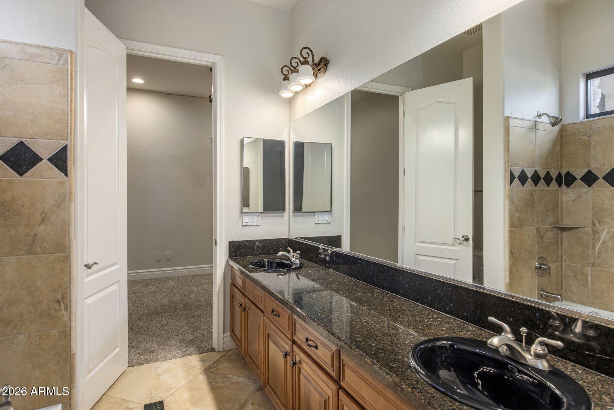 3215 East Constance Way Phoenix, AZ 85042 - Photo 19 of 40 a bathroom with a sink and a mirror