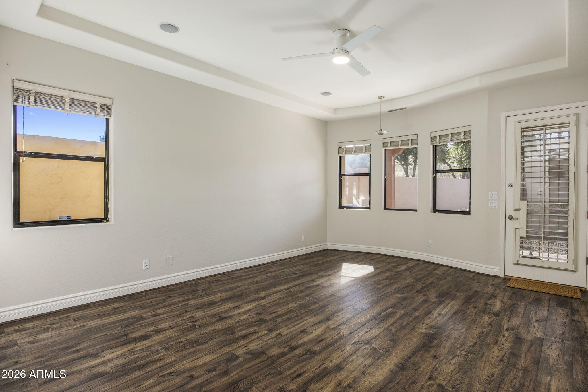 3215 East Constance Way Phoenix, AZ 85042 - Photo 21 of 40 a view of an empty room with window and wooden floor