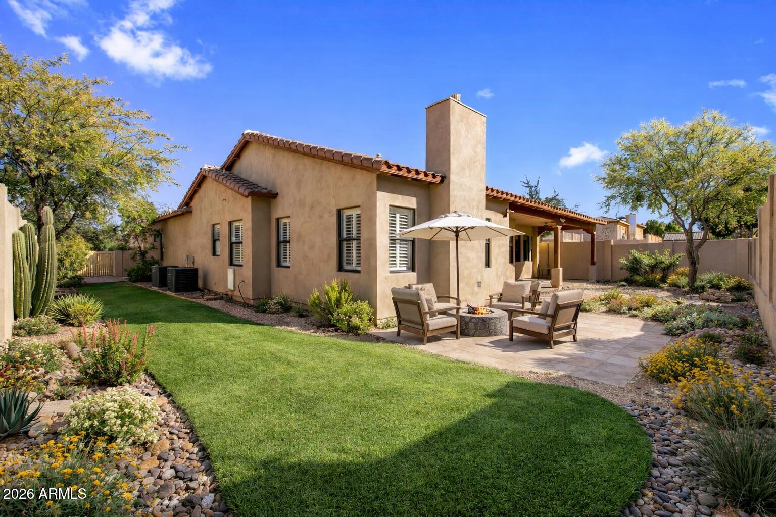 3215 East Constance Way Phoenix, AZ 85042 - Photo 28 of 40 a front view of a house with garden and sitting area