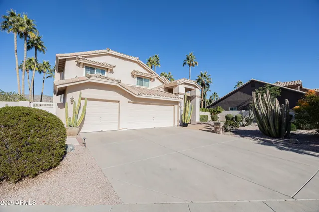 a view of a house with a yard and garage