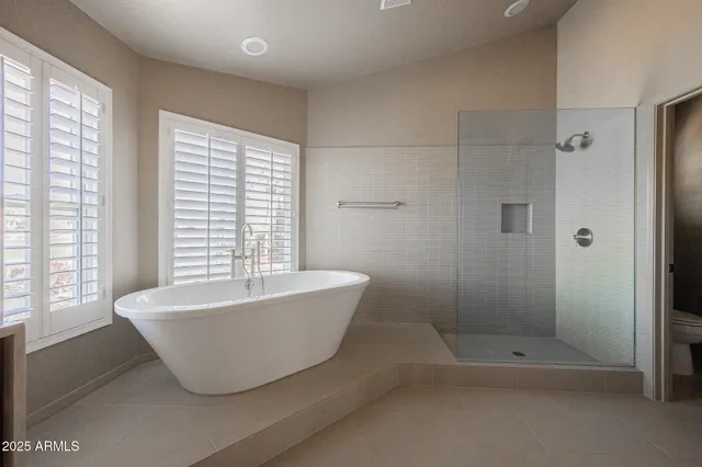 a bathroom with a bathtub and shower