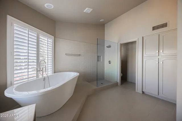 a spacious bathroom with a bathtub and a shower