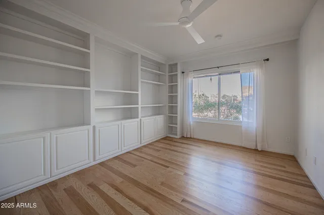 a view of empty room with wooden floor