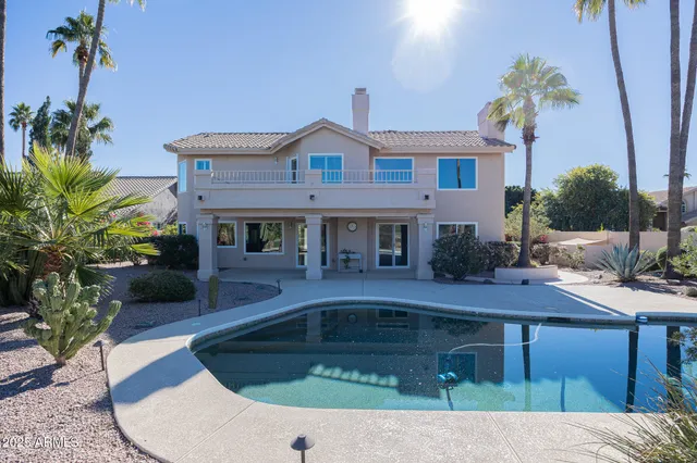 a view of a lake with a table and chairs