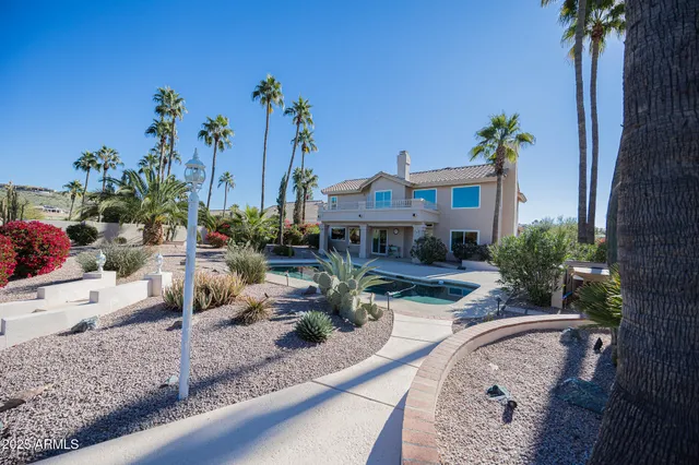 a view of a terrace with a table and chairs potted plants