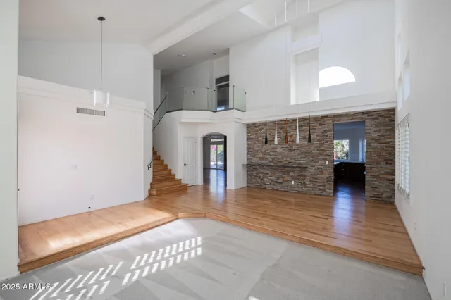 a view of a hallway with wooden floor and a fireplace