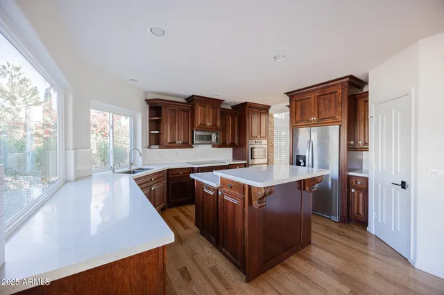 a kitchen with stainless steel appliances granite countertop a stove and a refrigerator