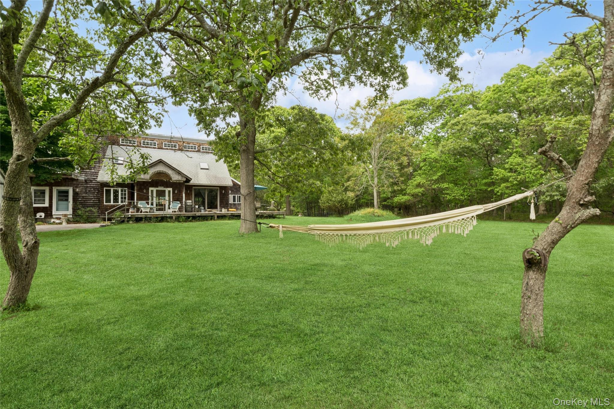 131 Red Creek Road Hampton Bays, NY 11946 - Photo 6 of 35 a view of a house with a backyard