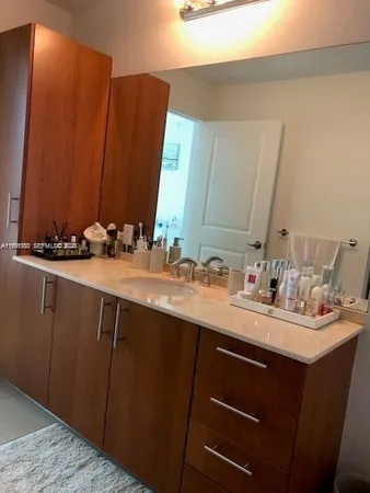 a bathroom with a sink vanity and a mirror