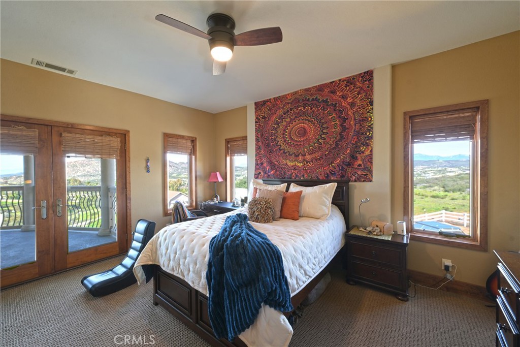 38101 Vía Lobato Temecula, CA 92592 - Photo 11 of 67 a bedroom with a bed and a large window