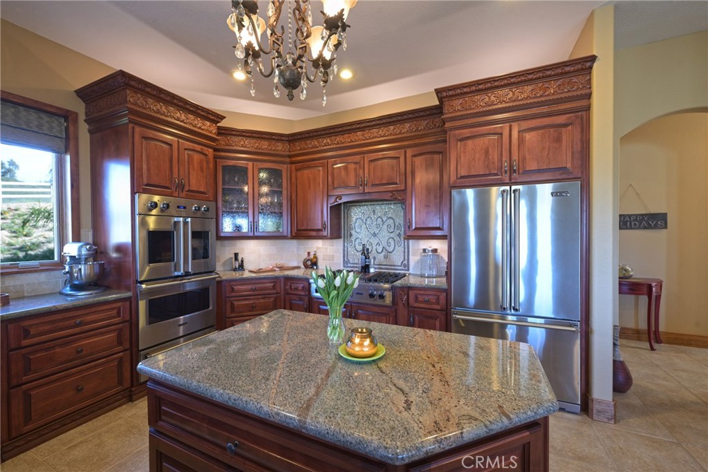38101 Vía Lobato Temecula, CA 92592 - Photo 16 of 67 a kitchen with sink refrigerator and cabinets