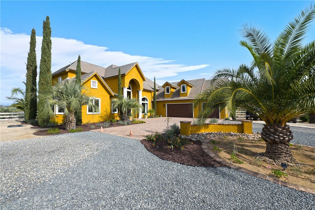 38101 Vía Lobato Temecula, CA 92592 - Photo 17 of 67 a view of a house with a yard and palm trees