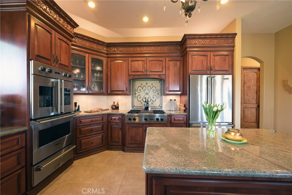 38101 Vía Lobato Temecula, CA 92592 - Photo 27 of 67 a kitchen with stainless steel appliances granite countertop a stove a sink and a refrigerator