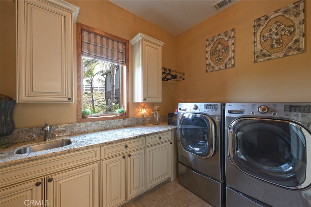 38101 Vía Lobato Temecula, CA 92592 - Photo 36 of 67 a utility room with sink dryer and washer