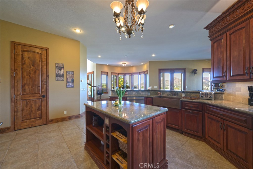 38101 Vía Lobato Temecula, CA 92592 - Photo 4 of 67 a kitchen with granite countertop a sink and cabinets