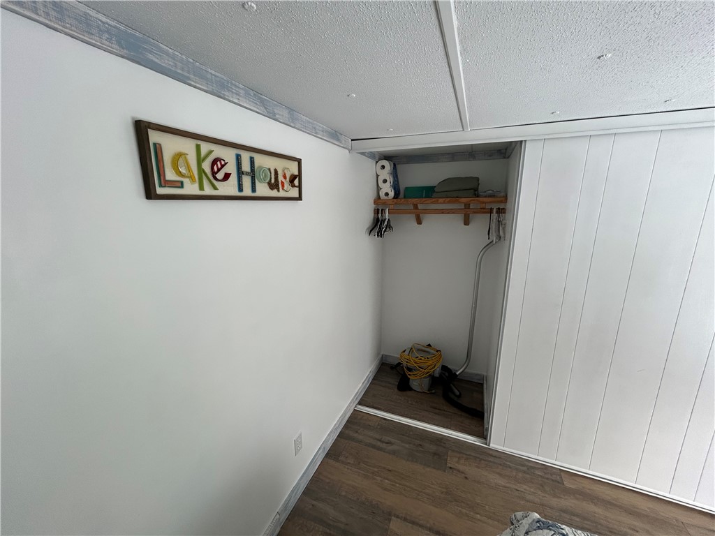 43 Sunset Cove Road Abbeville, SC 29620 - Photo 17 of 41 This interior hallway features warm flooring and a convenient built-in closet.