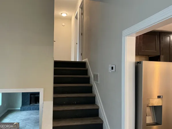 a view of entryway and hall with wooden floor