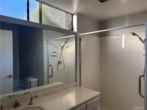 a bathroom with a shower and a sink