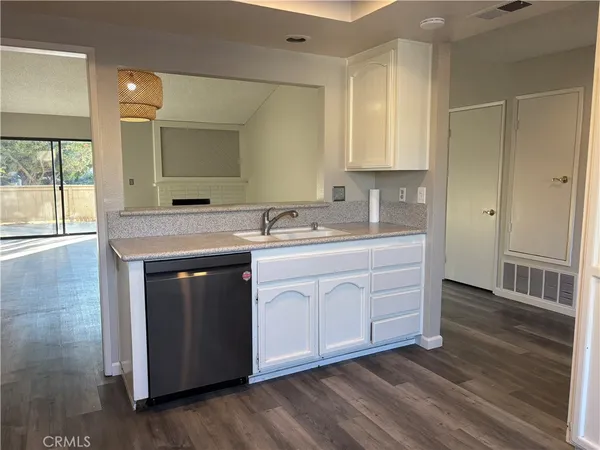 a kitchen with a sink stove and cabinets