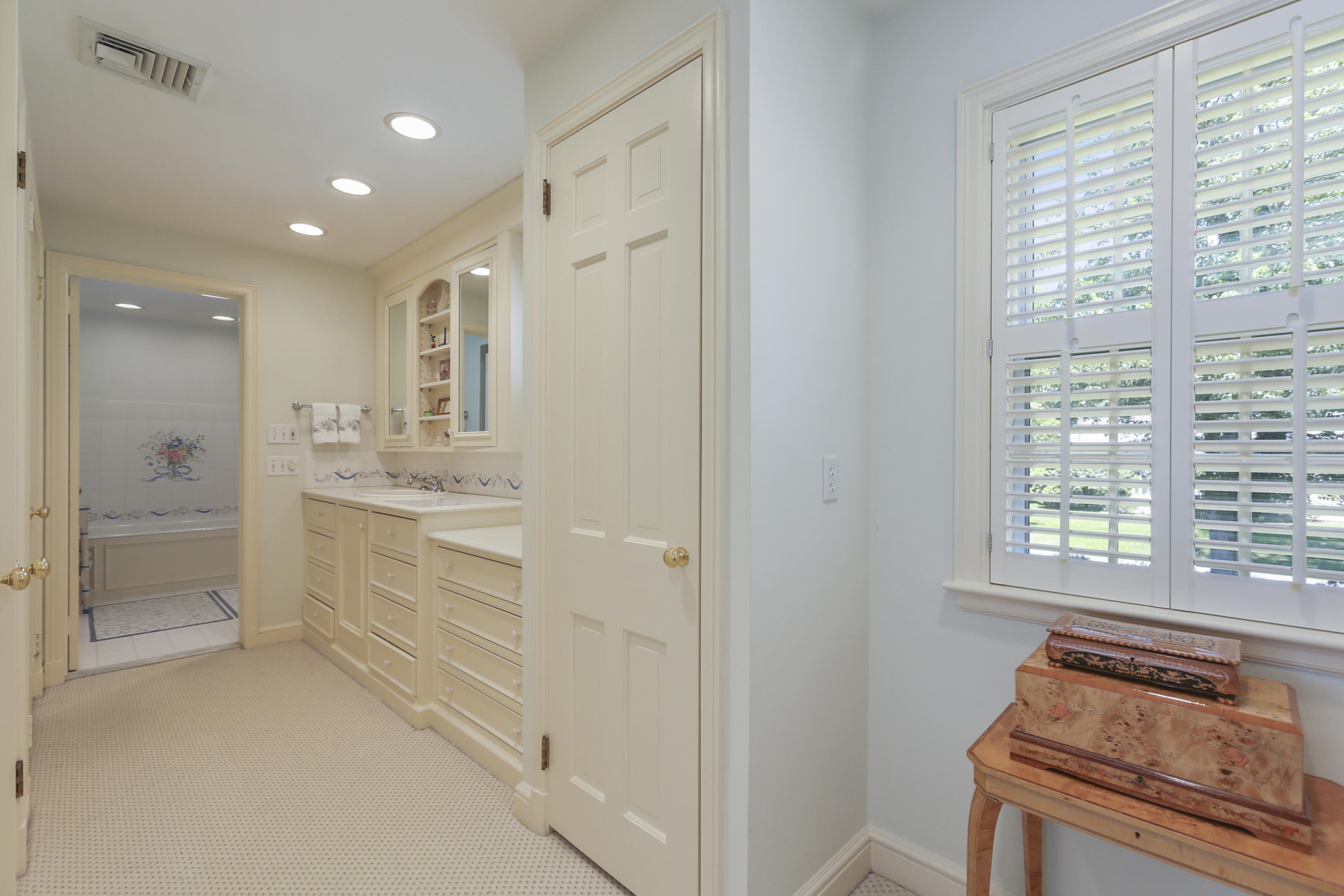 10 Deepwood Road Darien, CT 06820 - Photo 23 of 38 a bathroom with a shower sink and mirror