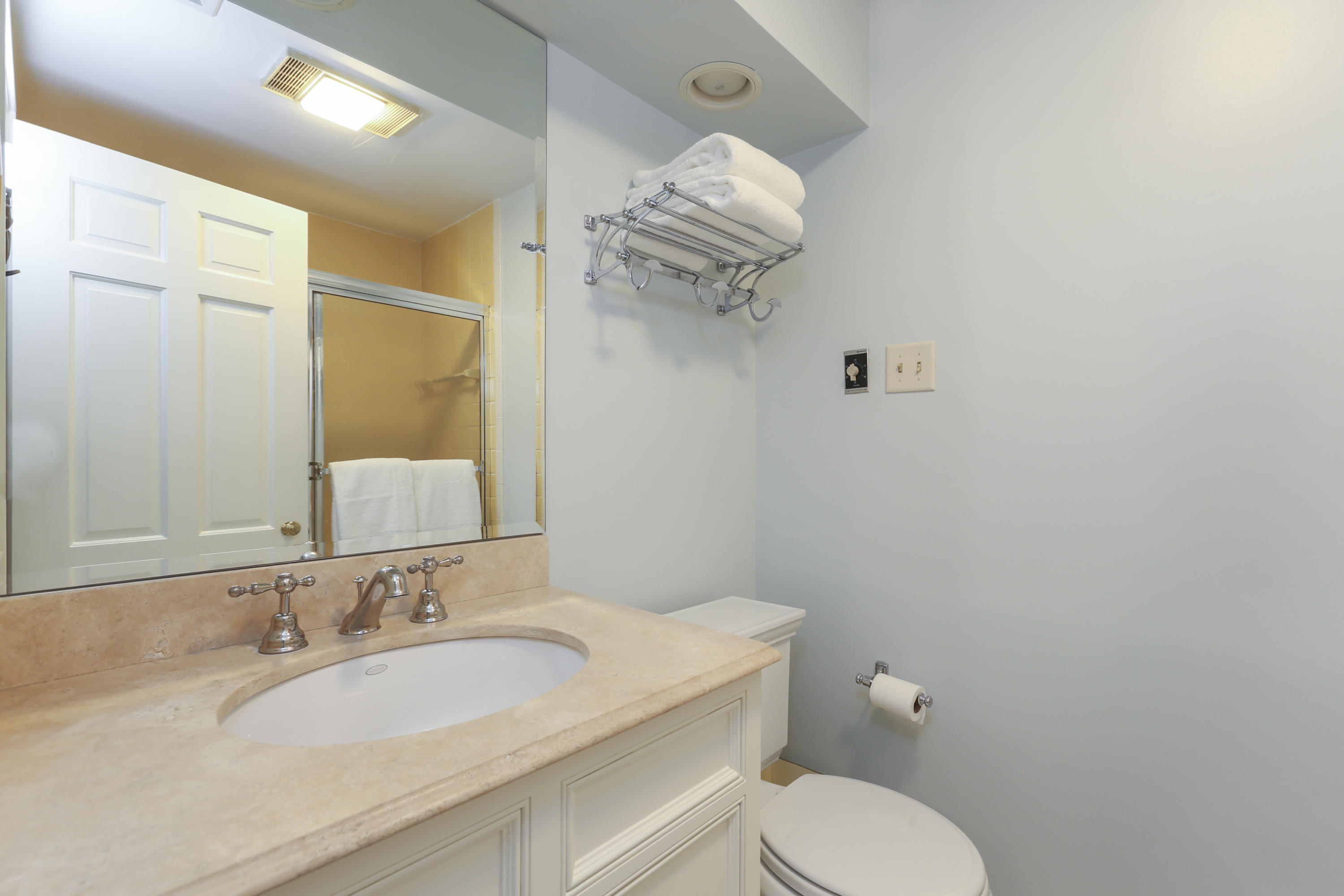 10 Deepwood Road Darien, CT 06820 - Photo 28 of 38 a bathroom with a sink a toilet and mirror