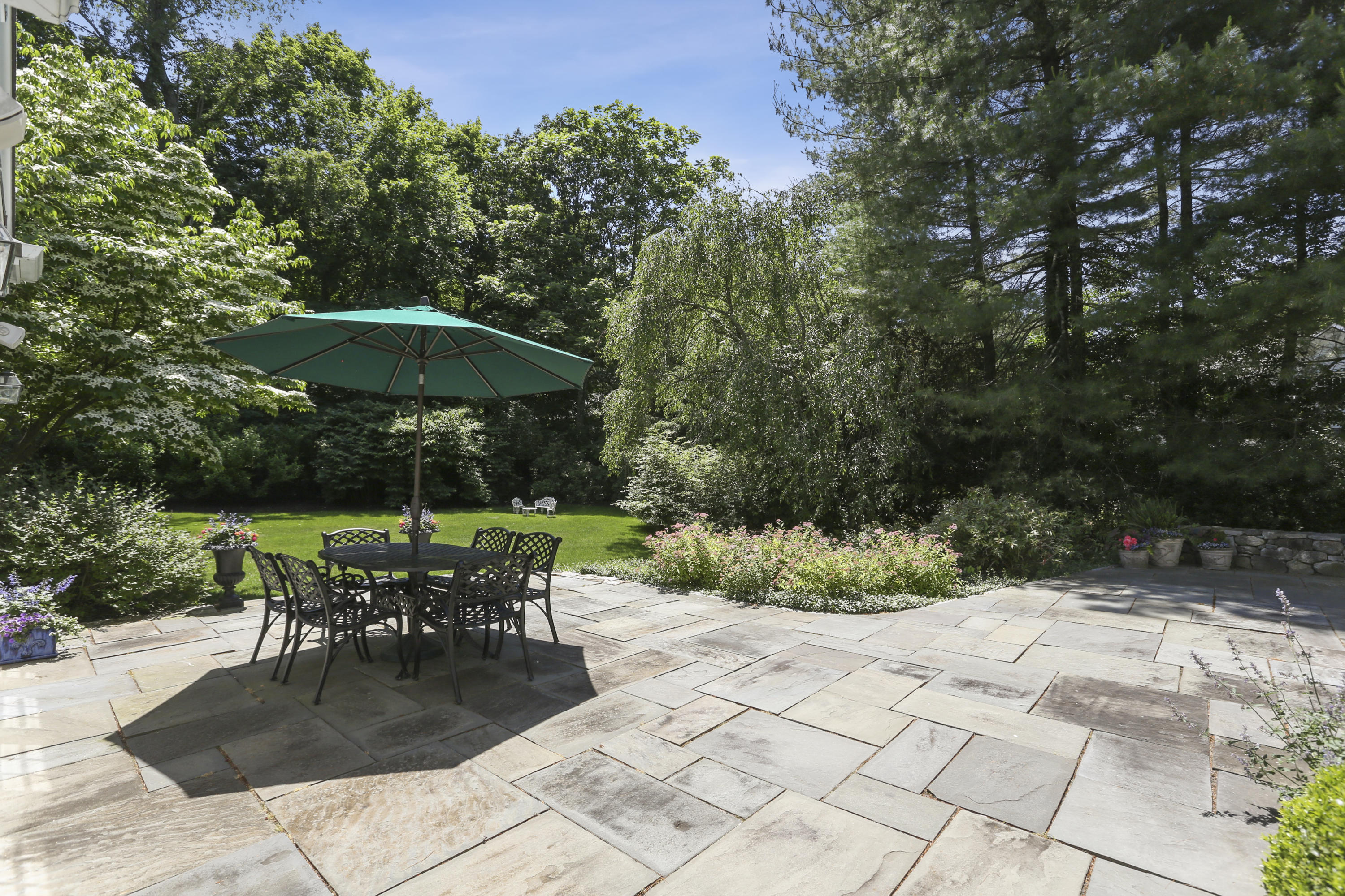10 Deepwood Road Darien, CT 06820 - Photo 31 of 38 a patio with a patio table and chairs