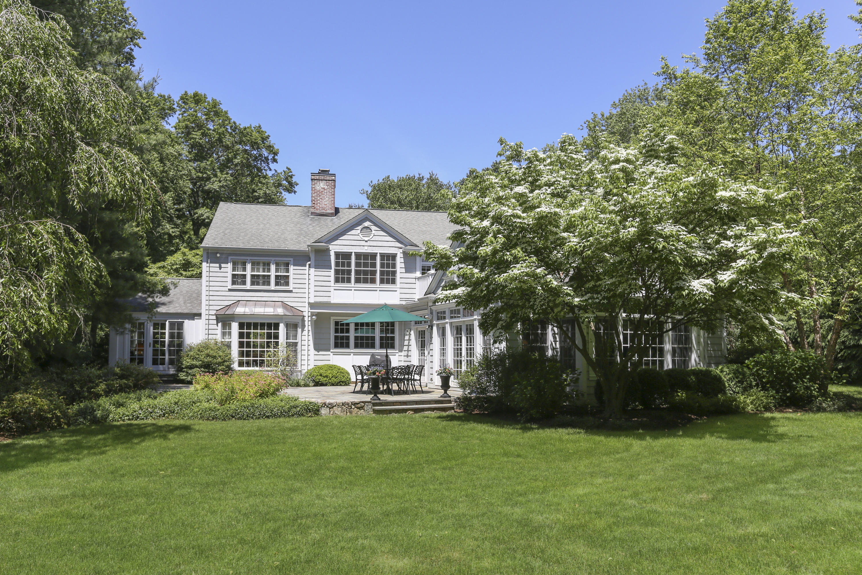 10 Deepwood Road Darien, CT 06820 - Photo 33 of 38 a front view of a house with a garden and trees