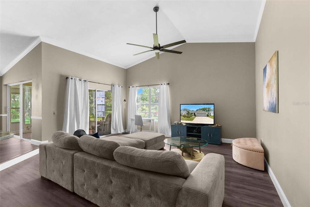13119 Topflite Court Hudson, FL 34669 - Photo 5 of 26 a living room with furniture a ceiling fan and a window