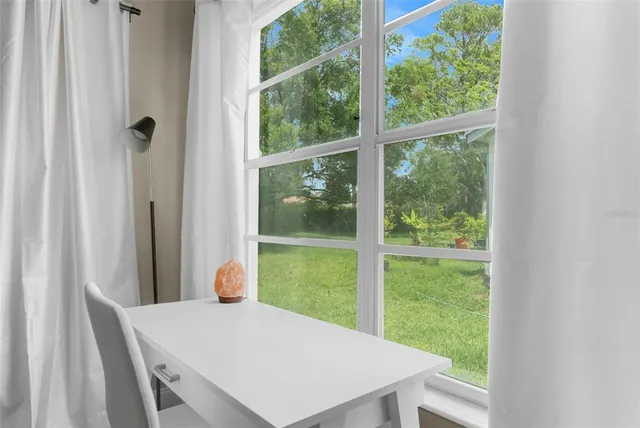 a view of a room with a table and chairs