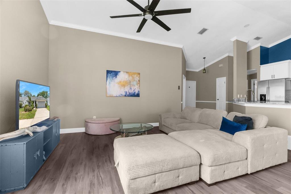 13119 Topflite Court Hudson, FL 34669 - Photo 8 of 26 a bedroom with a bed and a chandelier