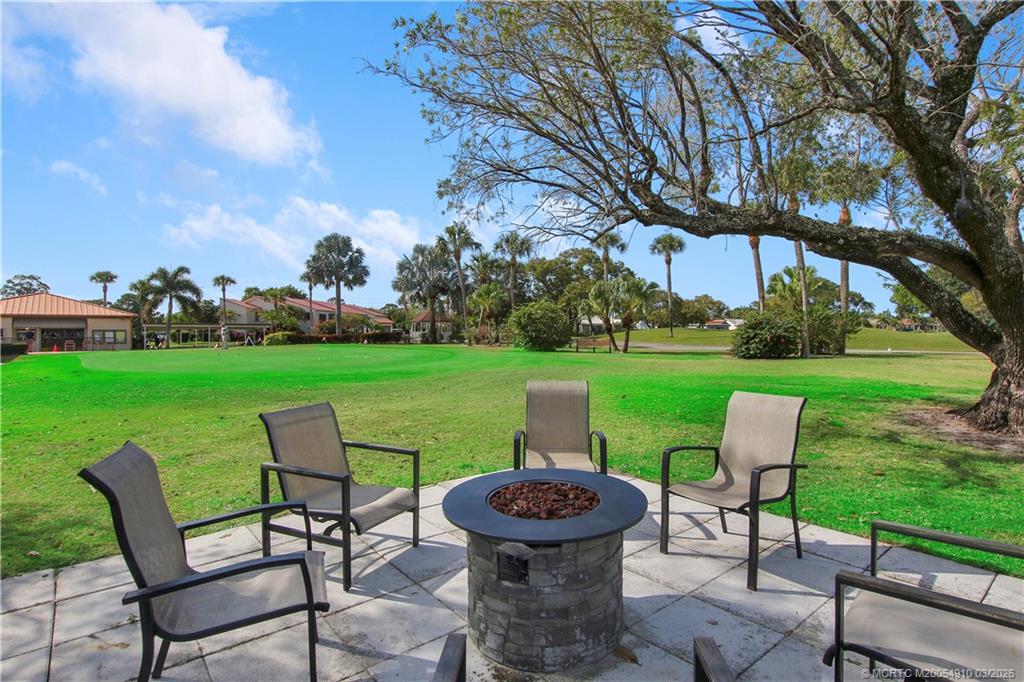 5323 Southeast Miles Grant Road, Unit 206 Stuart, FL 34997 - Photo 18 of 20 a view of a table and chairs in the garden