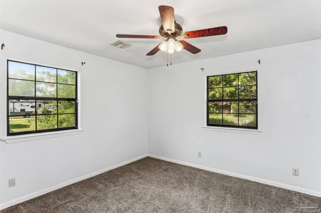 a bathroom with a granite countertop toilet sink and mirror