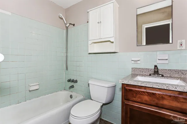 an empty room with fan and entrance