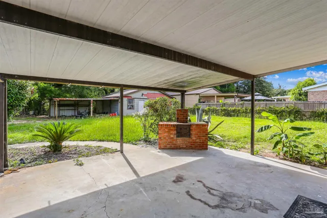 a view of a door with a bench and a yard