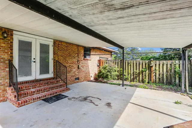 a backyard of a house with garden and outdoor seating