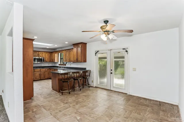 a view of kitchen with granite countertop cabinets and outdoor space