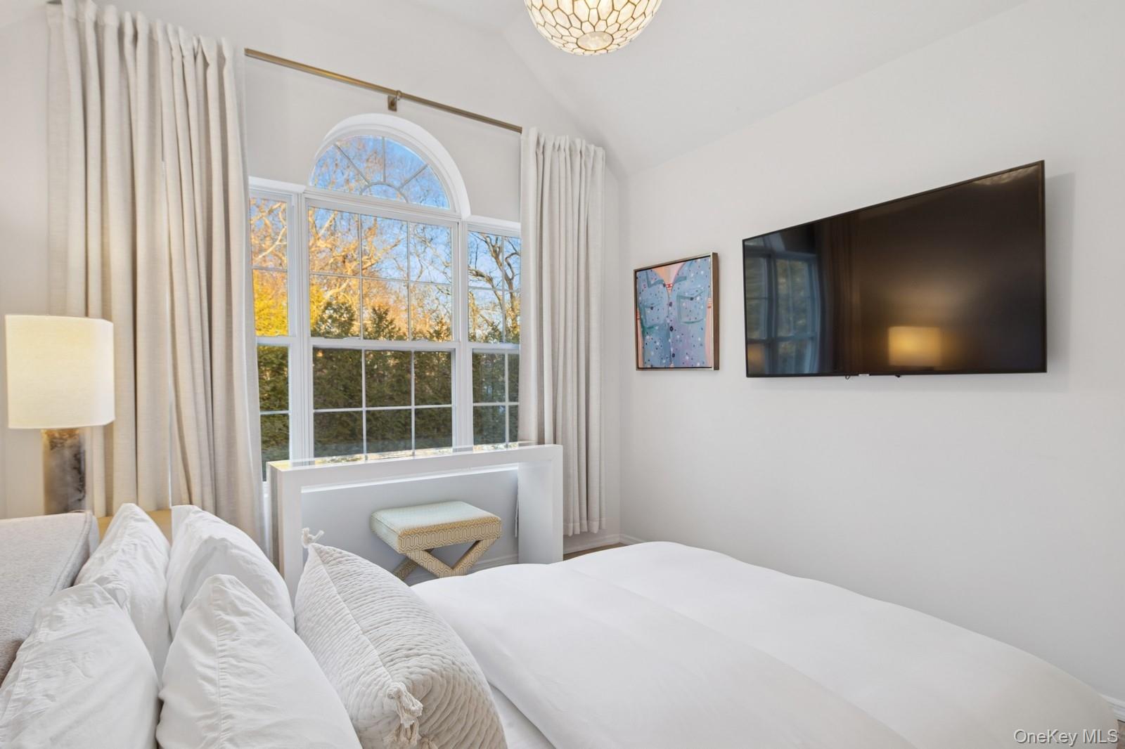 62 Sea Farm Lane Bridgehampton, NY 11932 - Photo 13 of 25 a bedroom with a bed and a flat screen tv