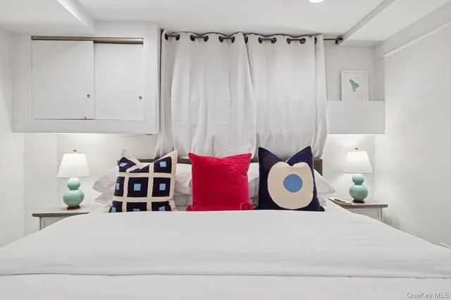 a view of a bedroom with bed and a window