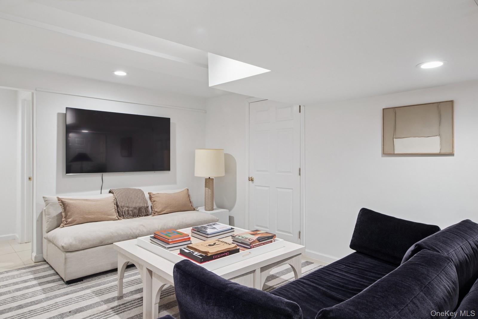 62 Sea Farm Lane Bridgehampton, NY 11932 - Photo 17 of 25 a living room with furniture and a flat screen tv