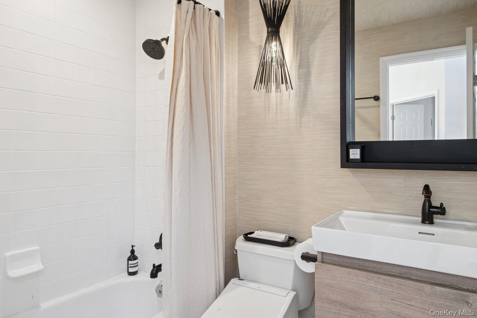 62 Sea Farm Lane Bridgehampton, NY 11932 - Photo 20 of 25 a bathroom with a sink a toilet and a bathtub