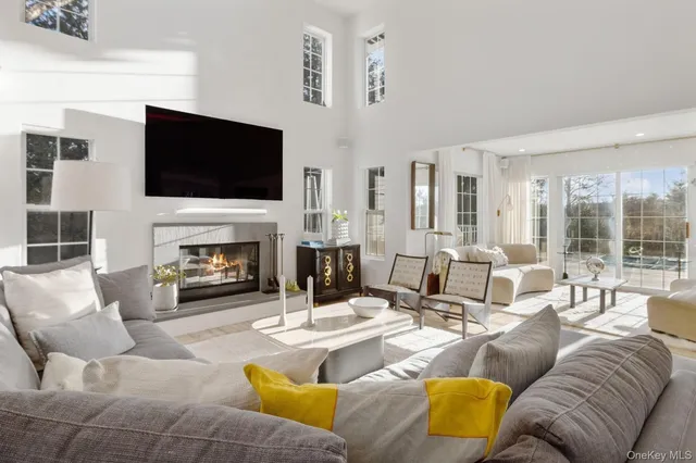 a living room with furniture fireplace and flat screen tv