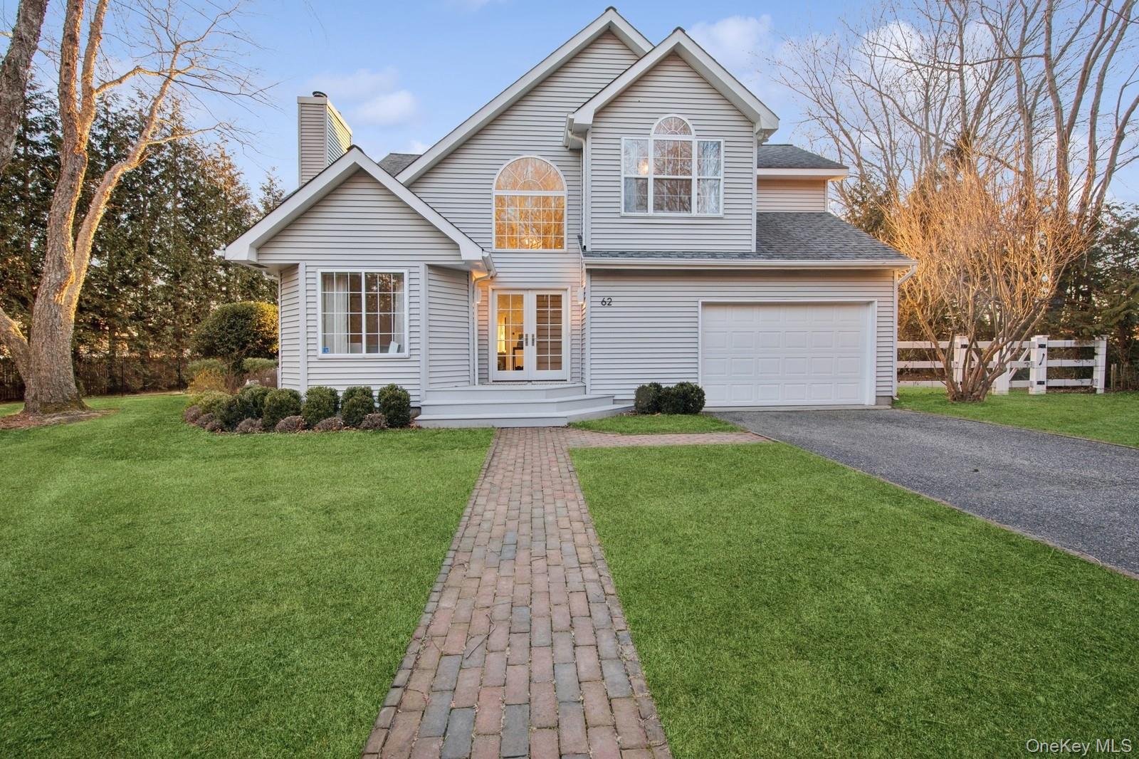 62 Sea Farm Lane Bridgehampton, NY 11932 - Photo 23 of 25 a front view of a house with a yard and trees